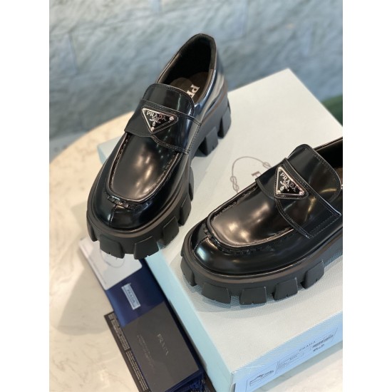 Prada Monolith Loafers Upper Detail in black Close-up view of black leather uppers and triangle logo details on Prada Monolith loafers