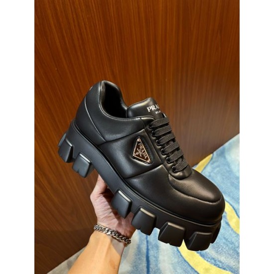 Prada Black Padded Trainer Handheld View Handheld view of a single black Prada padded nappa leather trainer showcasing the side profile and thick lugged sole