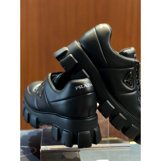 Prada Black Leather Trainers Heel Detail View Rear heel view of Prada black soft padded leather trainers displaying the silver heel logo branding