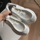 Handheld Front View Prada White Leather Trainers Hand holding a pair of white Prada leather and mesh trainers displaying lace detail