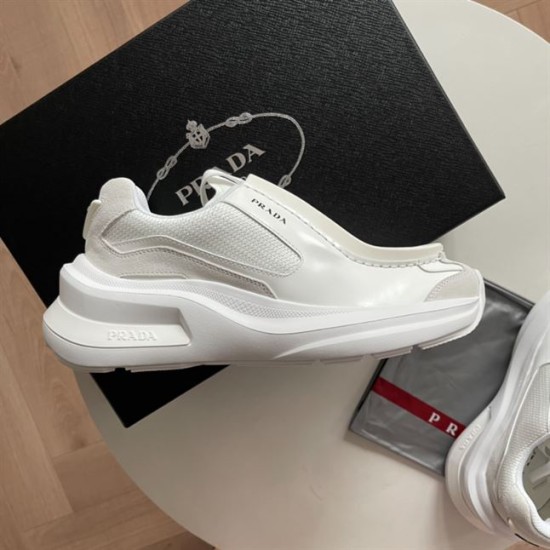 Prada White Trainer Side Profile with Box Side view of white Prada trainer set against a black shoebox background