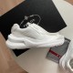 Prada White Trainer Side Profile with Box Side view of white Prada trainer set against a black shoebox background