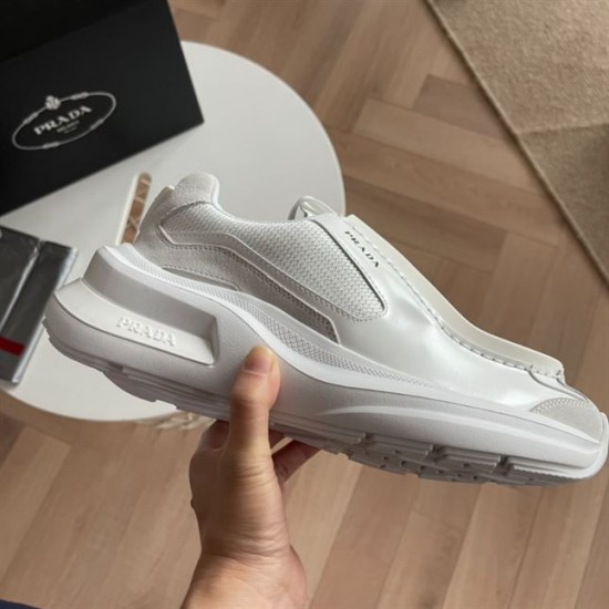 Prada White Trainer Midsole Profile Outer side profile of white Prada low top trainer held above table