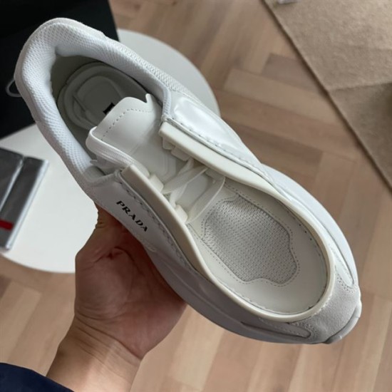 Prada White Low Top Trainer Overhead View Top-down perspective of white Prada leather low top trainer held in hand