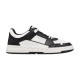 Side profile view of Valentino Freedots low-top leather trainers in black and white featuring studded midsole details.