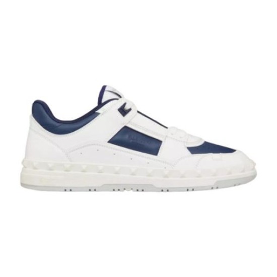 Studio profile shot of Valentino low-top leather trainer in white and navy blue.