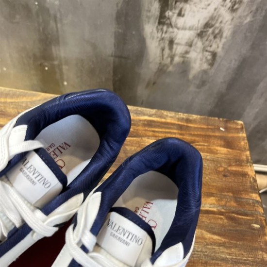 Overhead view showing padded navy blue collars and branded insoles of Valentino trainers in white and navy blue