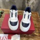 Top-down front view showing laces, tongue branding and perforated blue toe boxes of Valentino trainers in white and navy blue