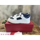 Pair of Valentino low-top white and navy trainers sitting on top of a red shoebox in white and navy blue
