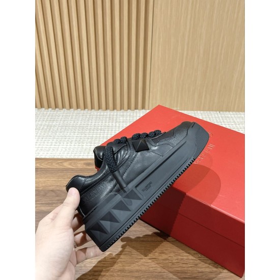 Valentino One Stud XL Black Leather Trainer In-Hand View Hand holding Valentino One Stud XL black leather trainer showing outer sole profile