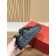 Valentino One Stud XL Black Leather Trainer In-Hand View Hand holding Valentino One Stud XL black leather trainer showing outer sole profile