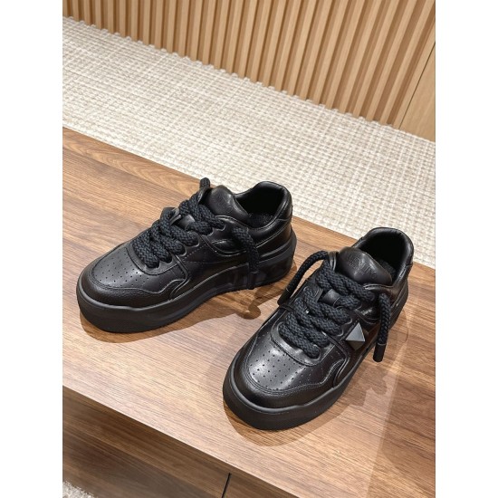 Valentino One Stud XL Black Leather Trainers Pair View Pair of Valentino One Stud XL black leather trainers placed on wooden tabletop