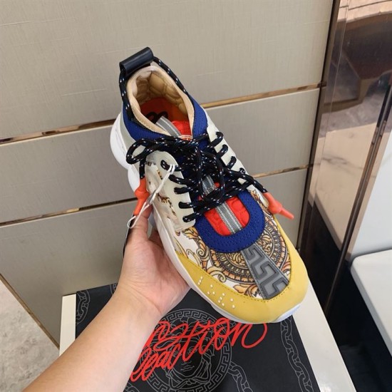 Versace Chain Reaction Trainer Front Upper View in yellow and white Front upper perspective of Versace Chain Reaction Trainer showing yellow suede toe cap and blue trim in yellow and white