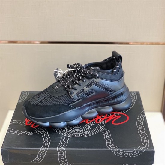 Outer side view of single Versace Chain Reaction black trainer on display box