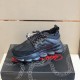 Outer side view of single Versace Chain Reaction black trainer on display box