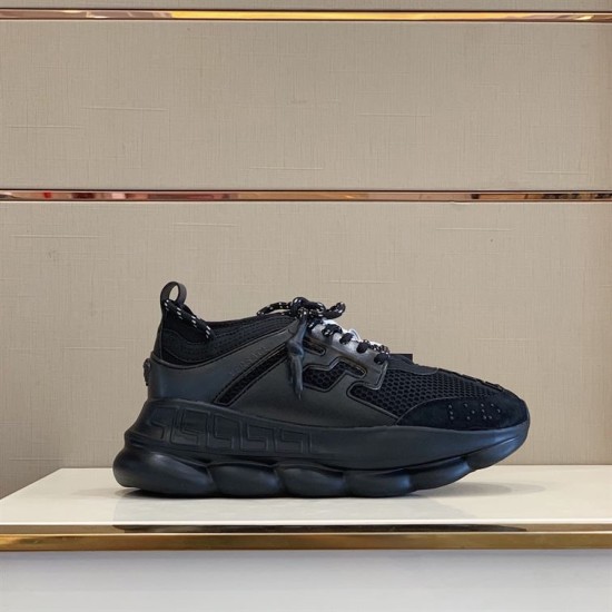 Side profile of Versace Chain Reaction black chunky trainers displayed on shelf