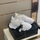 Versace White Trainers Pair on Box Pair of Versace white mesh trainers displayed on top of a black shoe box