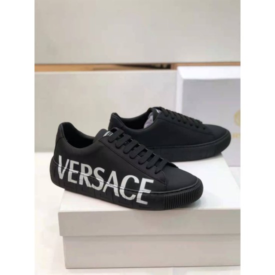 Versace Black Leather Trainers Pair in black and white Pair of Versace black leather low top trainers resting on a white shoe box