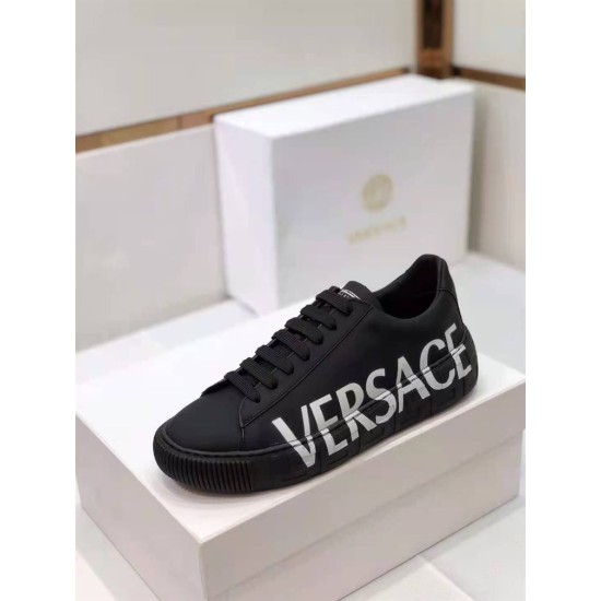 Versace Black Leather Trainers Lateral Angle in black and white Toe-down angle of a black Versace trainer showing white logo text on the lateral side