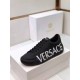 Versace Black Leather Trainers Lateral Angle in black and white Toe-down angle of a black Versace trainer showing white logo text on the lateral side