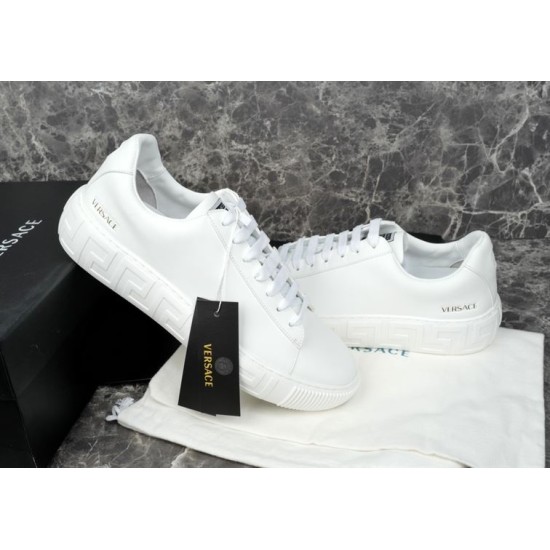 Versace White Trainers Angled View Angled side view of Versace white trainers highlighting embossed sole