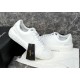 Versace White Trainers Angled View Angled side view of Versace white trainers highlighting embossed sole