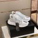 Versace Trigreca Trainers Angle View in white and gold Three-quarter elevated view of white Versace Trigreca leather trainers on black box in white and gold