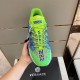 Top-down view of the green and blue trainer showing the toe box and central tongue branding