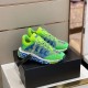 Three-quarter angle view of green and blue luxury trainers resting on their packaging box
