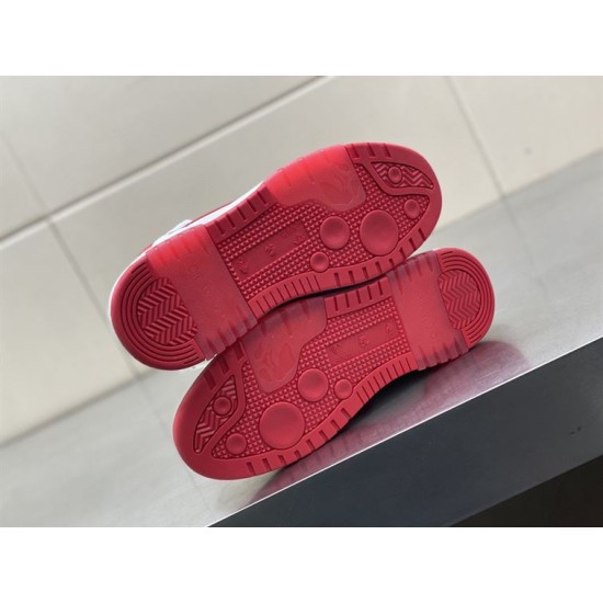 Underside view showing red rubber tread pattern on Off-White trainers