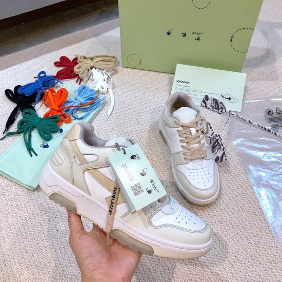 Off-White Out Of Office Trainer Handheld View Hand holding Off-White Out Of Office white and beige leather trainer