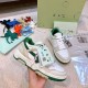 Off-White Out Of Office White Green Trainer Handheld View Hand holding Off-White Out Of Office trainer showing lateral side detail