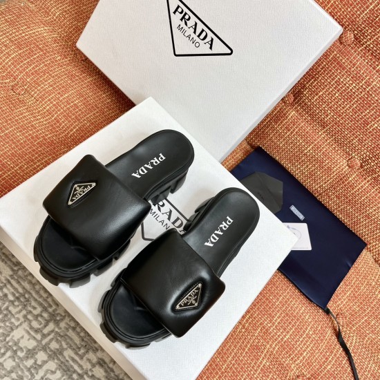 Prada Black Slides Overhead View Top-down view of Prada black slides presented on top of branded packaging boxes