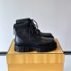 Angled side view of black Fendi Men's FF Jacquard And Leather Biker Boots on box Angled side view of black Fendi Men's FF Jacquard And Leather Biker Boots resting on a branded yellow box
