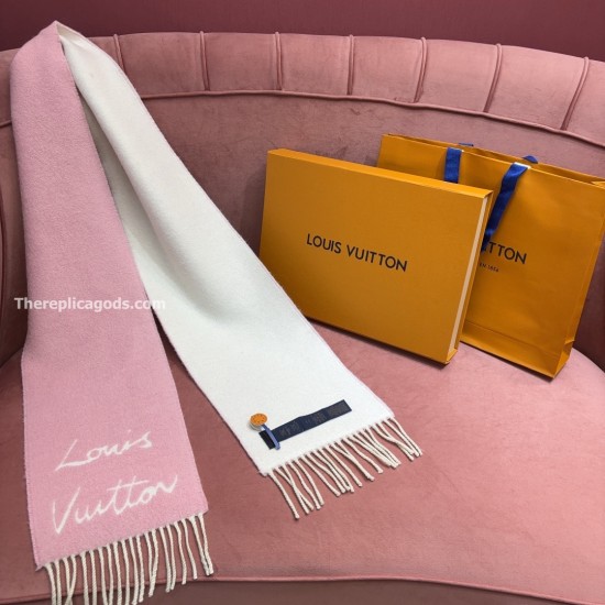 L Women's Fluffygram Scarf Pink Cashmere Blend Display View L Women's Fluffygram Scarf Pink Cashmere Blend draped on a velvet sofa with contrast fringe and brand details