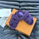 Angled view of Hermes Chypre slide sandals in violet with dust bag
