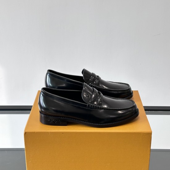 Pair of L Men's Patent Leather Loafers In Black resting on a shoe box