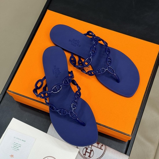 Hermès Island Violet Iris Sandals Overhead View Top-down angle view of Hermès Island Violet Iris sandals displayed on an orange luxury presentation box