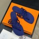 Hermès Island Violet Iris Sandals Overhead View Top-down angle view of Hermès Island Violet Iris sandals displayed on an orange luxury presentation box