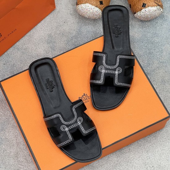 Angled layout view of Hermes black sandals displaying detailed strap stitching