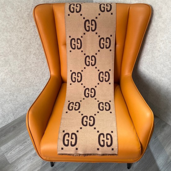 Beige reverse side of the Gucci Women's Brown Jacquard Wool Silk Scarf draped over a chair