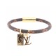 L Men's NBA Leather Bracelet Detail View Angled view of the L Men's NBA Leather Bracelet showing the gold-tone clasp and charms