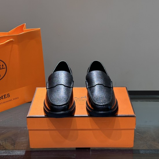 Hermes Men's Guillaume Black Loafers Front Pair Front view pair of Hermes Men's Guillaume Textured Leather Loafers In Black resting on an orange shoe box