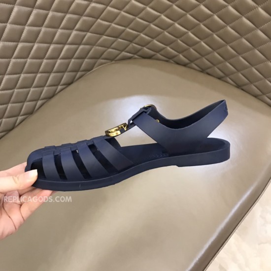 Gucci Blue Rubber Sandals Front Toe View in blue and white Gucci rubber buckle strap sandals in blue held up showcasing the rounded toe box and cage straps in blue and white