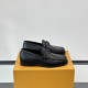 Side profile of L Men's Major Loafers In Black Grain Leather resting on an orange shoe box against a plain backdrop.