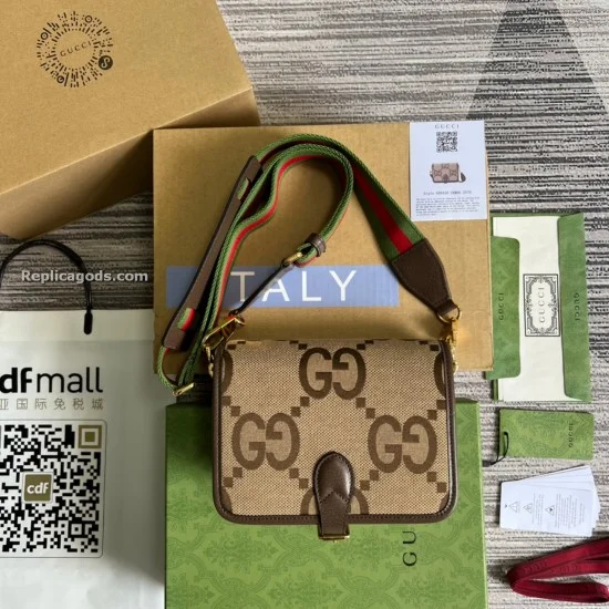 Men's Top-Down Presentation View with Unboxed Accessories Men's Detailed top-down view of the brown jumbo GG canvas shoulder bag and its branded presentation boxes