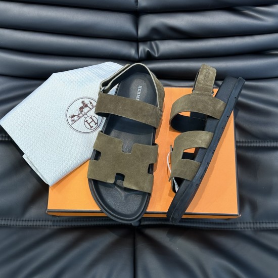 Hermes Etoupe Suede Flat Sandals Angled Box View in black Hermes etoupe suede flat sandals angled view resting on orange presentation box in black