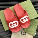 Gucci Red Slide Sandals Pair Top View in red and white Top-down view of a pair of Gucci red slide sandals highlighting the textured footbed in red and white