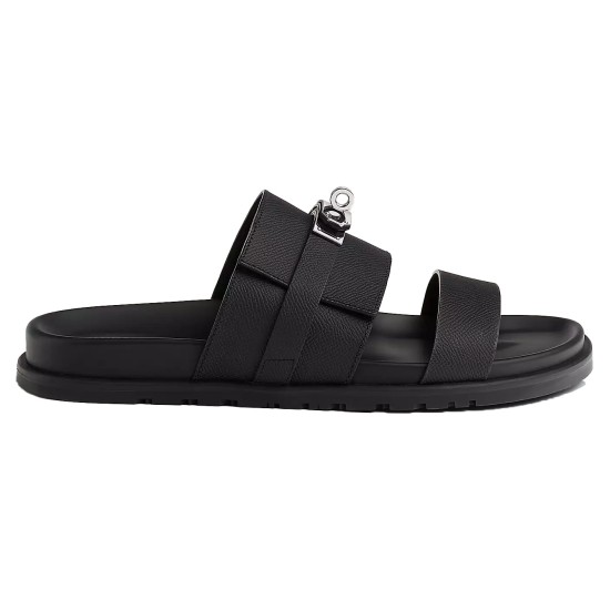 Hermes black leather sandals profile view Side profile view of Hermes black leather sandals showing curved sole and strap hardware