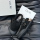Dior Black Nubuck Calfskin Tokio Mules Box Presentation Top angled view of the black nubuck calfskin mules displayed next to a branded presentation box and dust bag